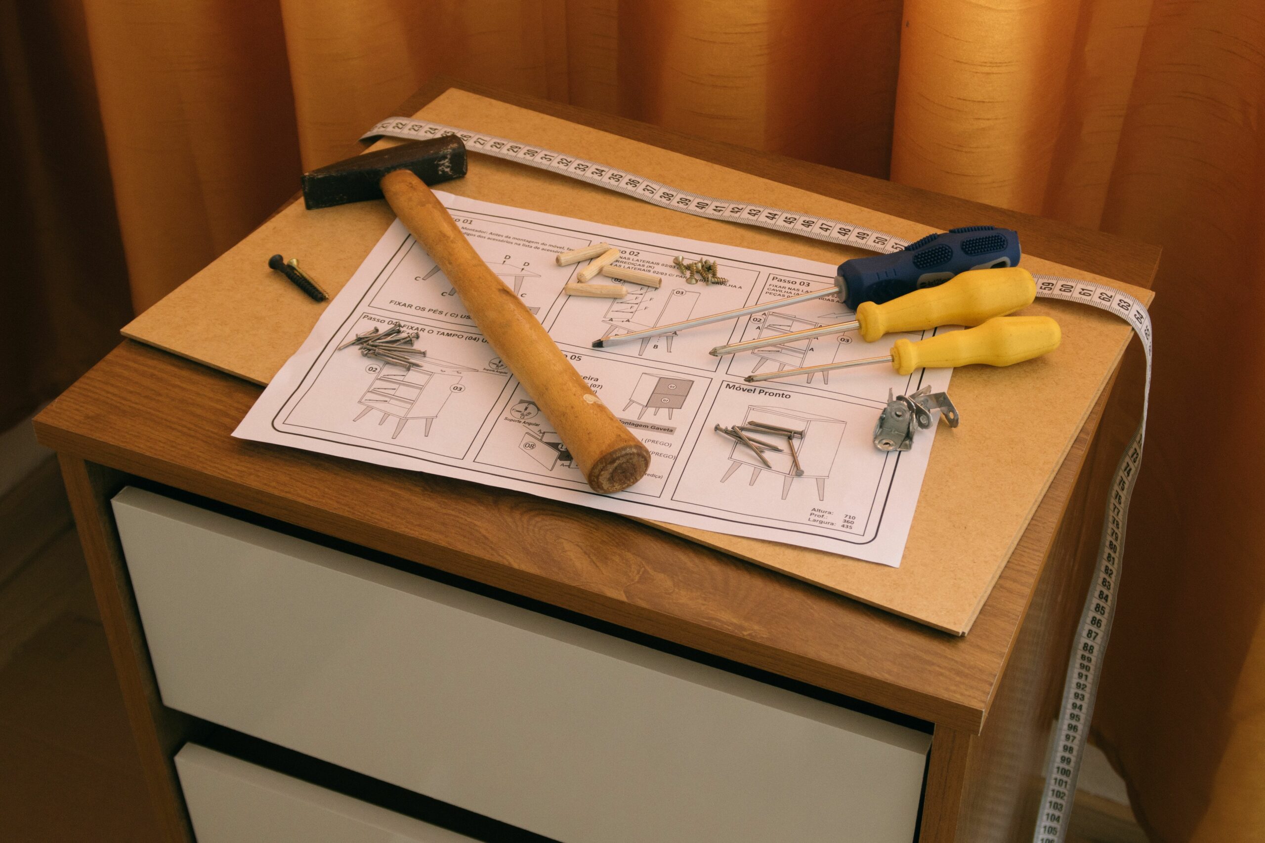 Assembly tools laid out beside furniture instructions